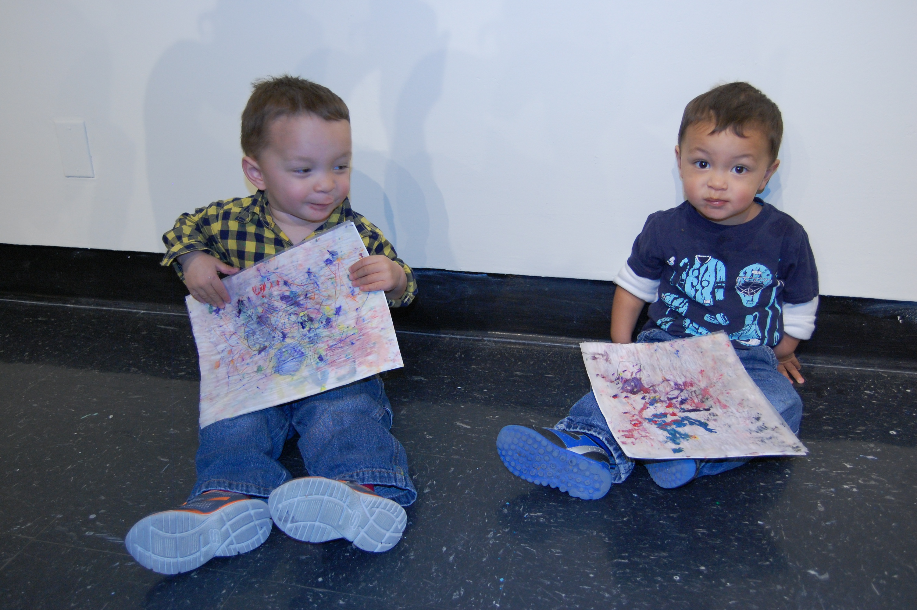 two children with art from the workshop