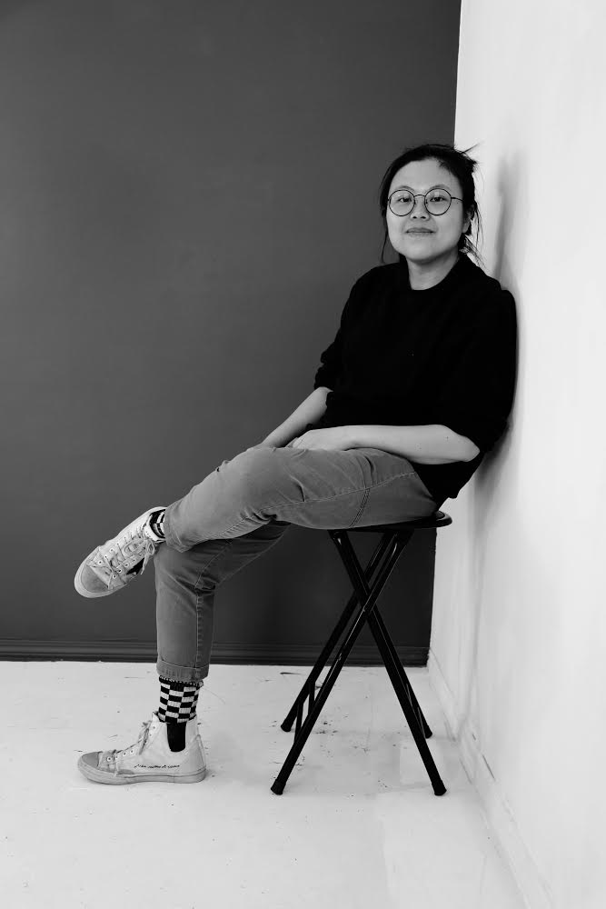 Wang Chen sitting on a chair